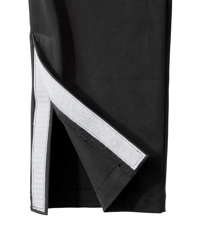 Bottom of black dressing pants with velcro tab closures and magnet leg opening