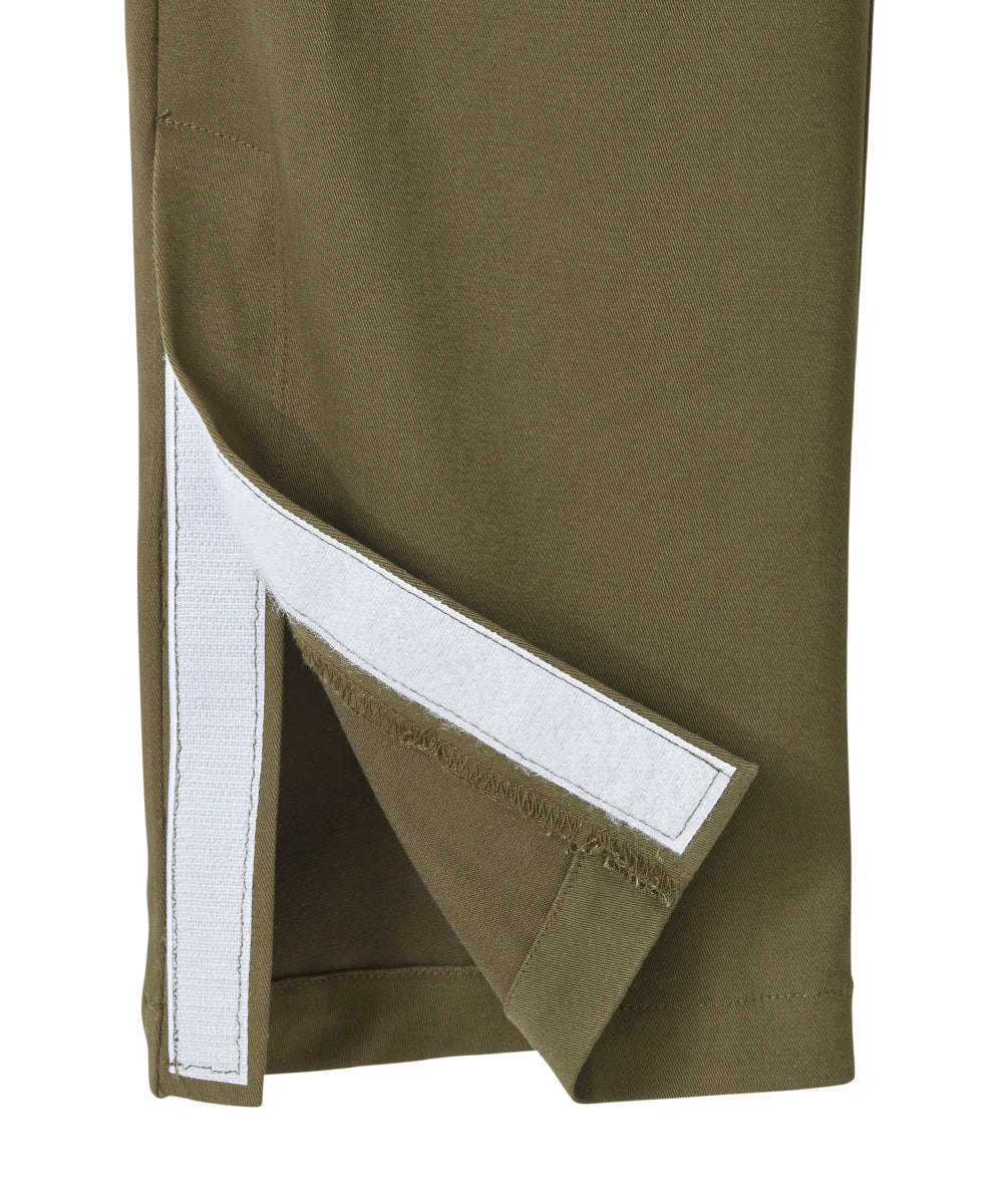 Bottom of olive dressing pants with velcro tab closures and magnet leg opening