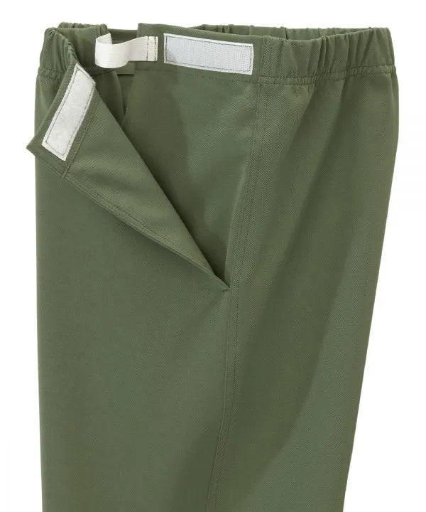 Women’s olive pants with side closure, adjustable straps, and loop fasteners on waistband. close-up of side closure
